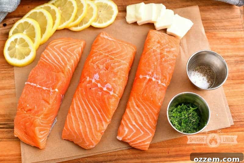 Smoky Cedar Plank Salmon with Zesty Lemon Herbs 3 3 salmon filets, lemon slices, butter slices, herbs, and salt and pepper on cutting board