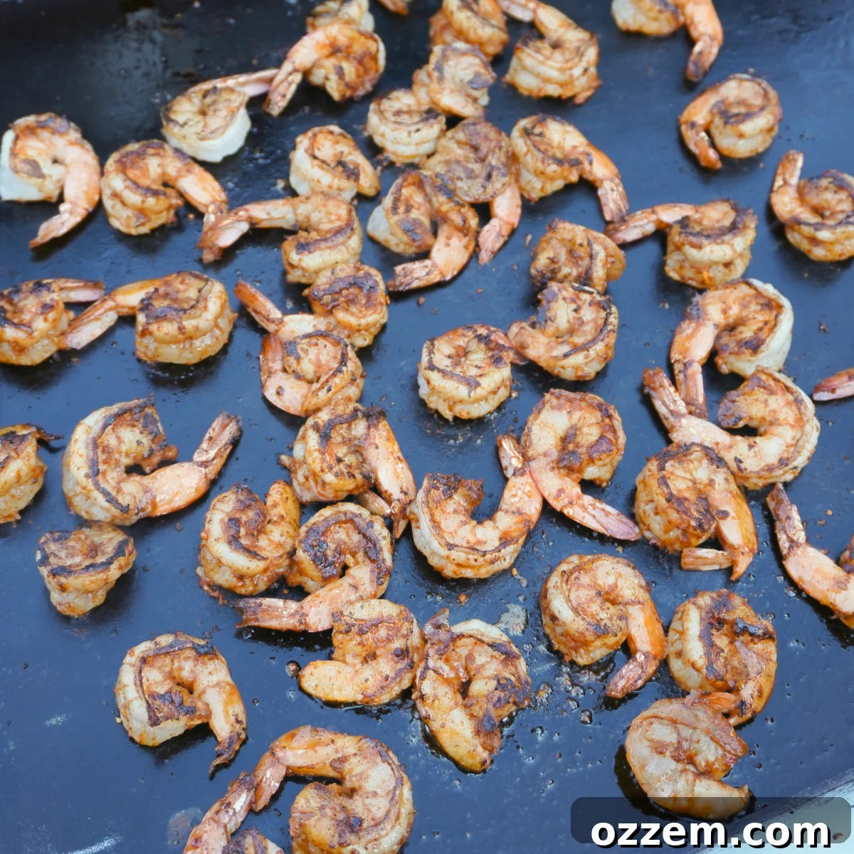 Flame-Kissed Shrimp with Zesty Chili Aioli 4 Close-up of seasoned shrimp cooking on a hot griddle, developing a perfect crust.