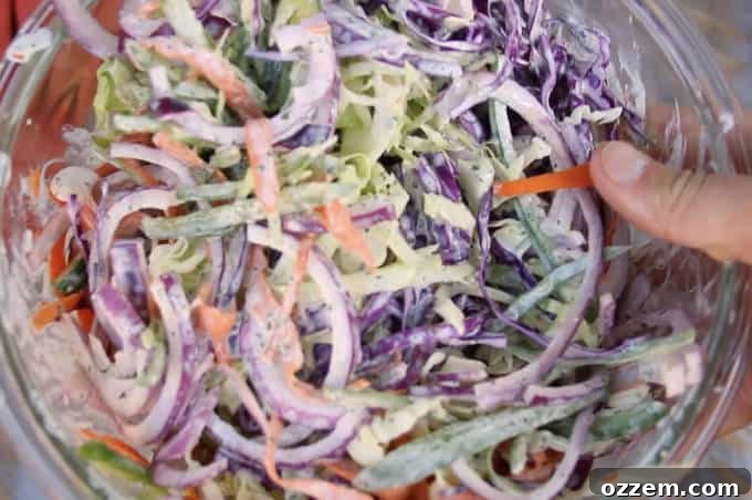 dressed jalapeño lime cilantro slaw in a glass bowl close up