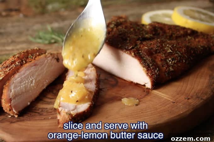 Hunter's Smoked Wild Turkey Breast 10 Close-up of freshly sliced smoked wild turkey breast on a cutting board, being drizzled with a bright orange-lemon butter sauce, showcasing its juicy texture and golden crust.