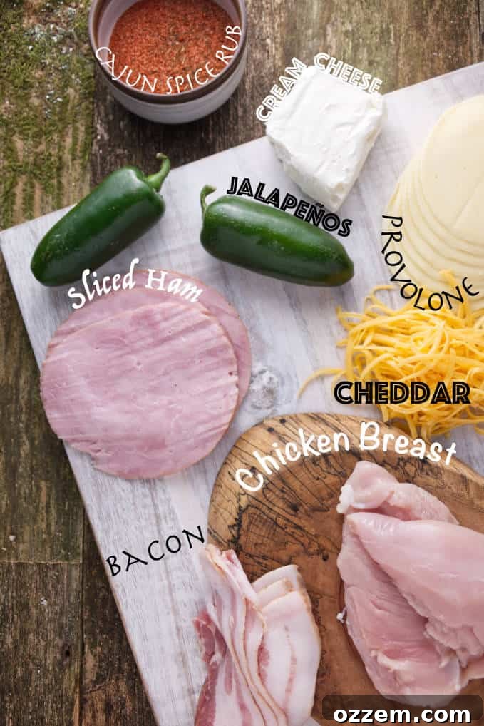 Ingredients for smoked jalapeño popper chicken: cajun spice rub, cream cheese, jalapeños, sliced ham, provolone cheese, cheddar cheese, bacon, and chicken breast.