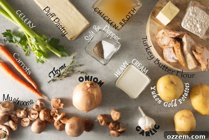 Collection of fresh ingredients for Ninja Foodi turkey pot pie, including celery, carrots, mushrooms, onion, thyme, puff pastry, chicken broth, salt, pepper, heavy cream, garlic, Yukon Gold potatoes, turkey, butter, and flour