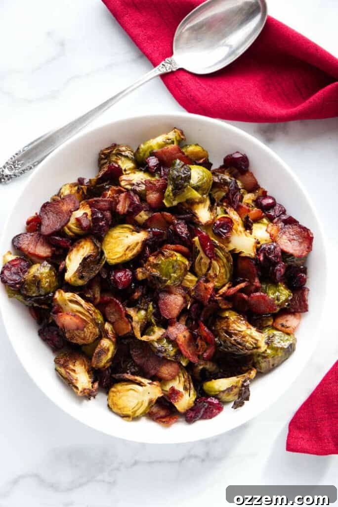 Overhead shot of a rustic serving bowl filled with air fried Brussels sprouts and bacon, accompanied by a serving spoon, highlighting their crisp texture and golden-brown perfection.