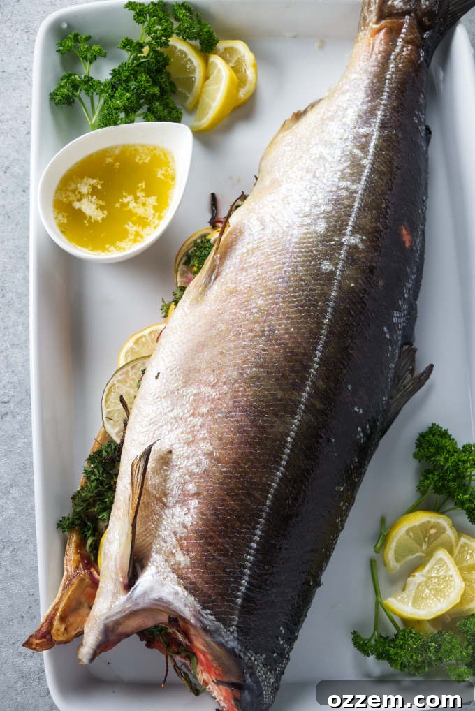 Grilled Whole Salmon Made Simple 2 Whole salmon stuffed with citrus and aromatics on serving platter