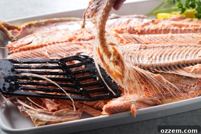 Grilled Whole Salmon Made Simple 15 Removing the spine and bones after cooking a whole salmon.