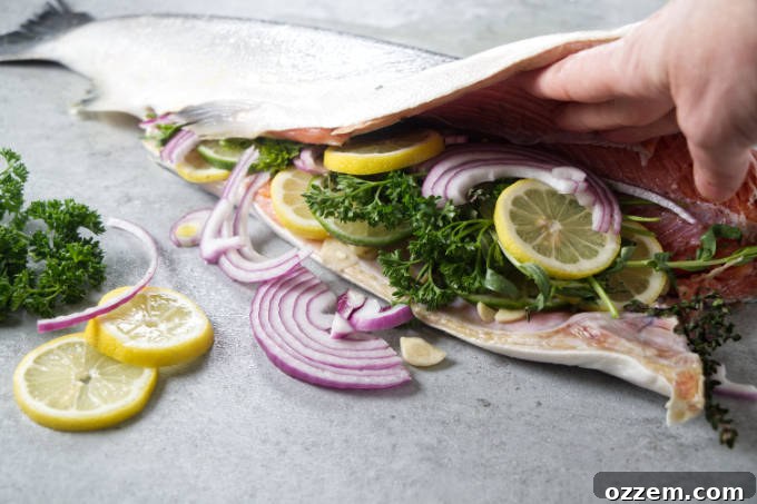 Grilled Whole Salmon Made Simple 8 Stuffing a whole salmon with lemon, onion, garlic, and herbs.