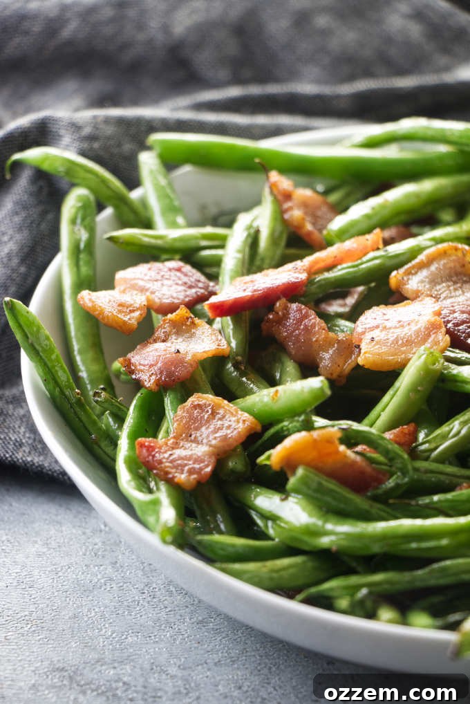 A generous serving of air fryer green beans with bacon in a rustic bowl, ready to be enjoyed as a side dish.