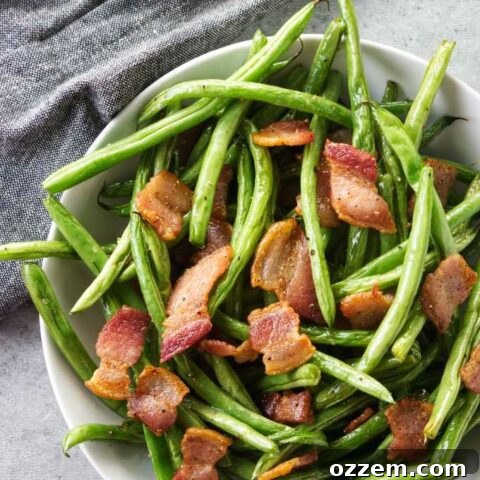 A bowl of green beans with bacon.