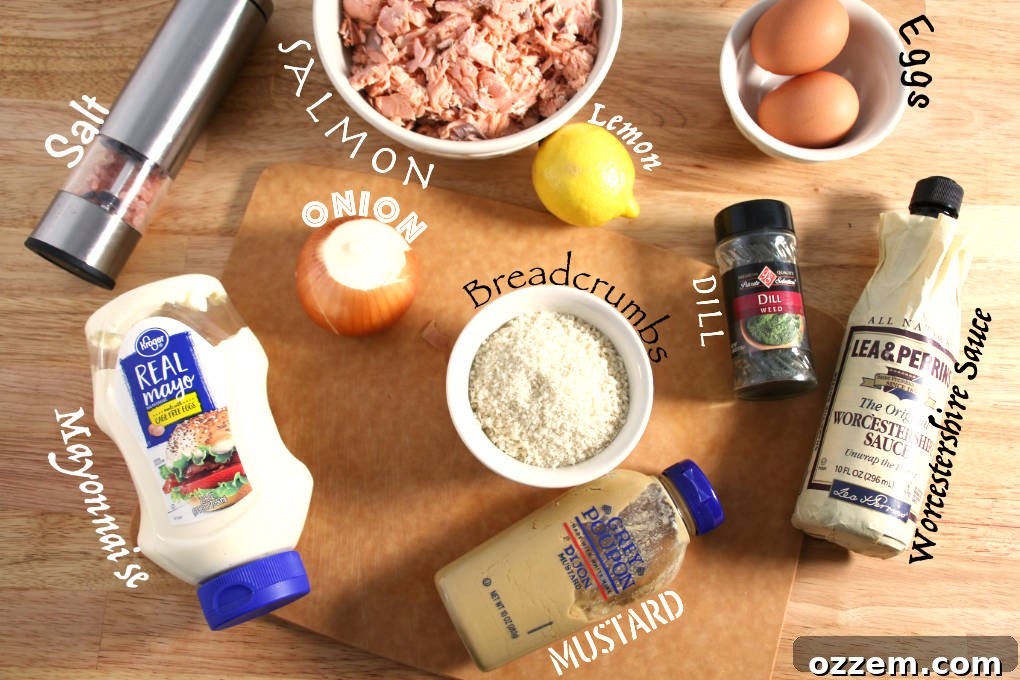A vibrant flat lay of all essential ingredients for air fryer salmon patties: cooked salmon, diced onion, fresh lemon, golden Panko breadcrumbs, creamy mayonnaise, tangy mustard, Worcestershire sauce, eggs, and a sprinkle of salt.