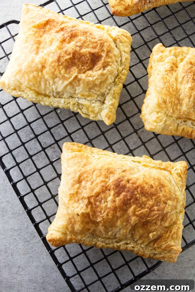 Freshly baked air fryer breakfast pockets cooling on a wire rack, ready to be enjoyed or stored.
