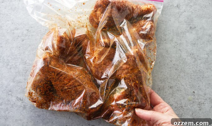 Chicken legs in a plastic bag with bbq dry rub seasoning.
