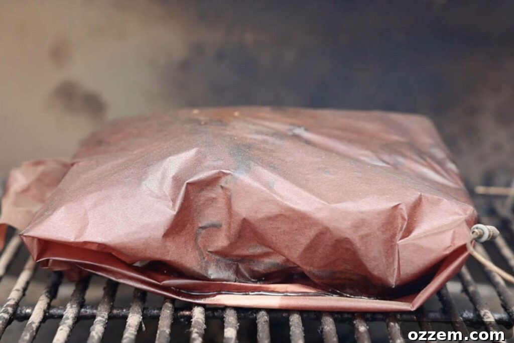 Wrapped pork butt on the smoker.