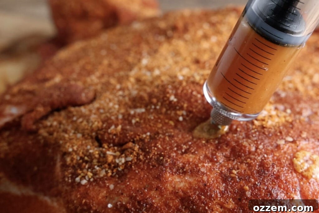 Injecting pork butt with marinade.