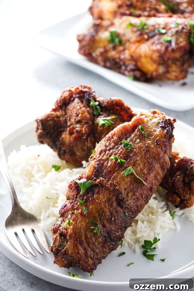Air fryer turkey wings on a bed of rice.