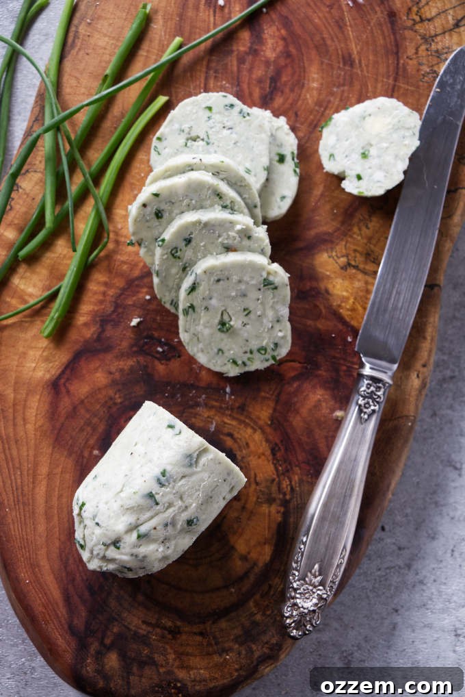 A log of blue cheese butter sliced into rounds for steak, ready to be served or stored.