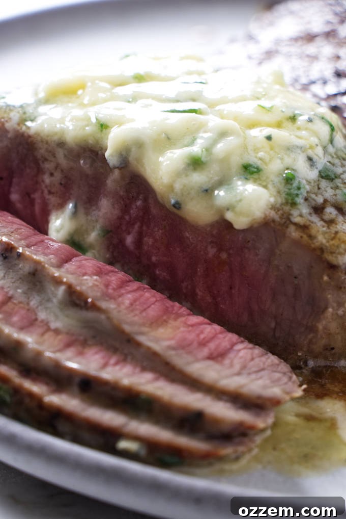 Blue cheese butter melting beautifully on a grilled steak, creating a rich sauce.