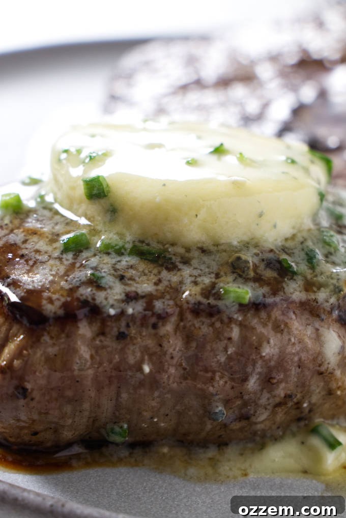 Grilled chuck roast with blue cheese butter melting on top, showcasing its delicious appeal.
