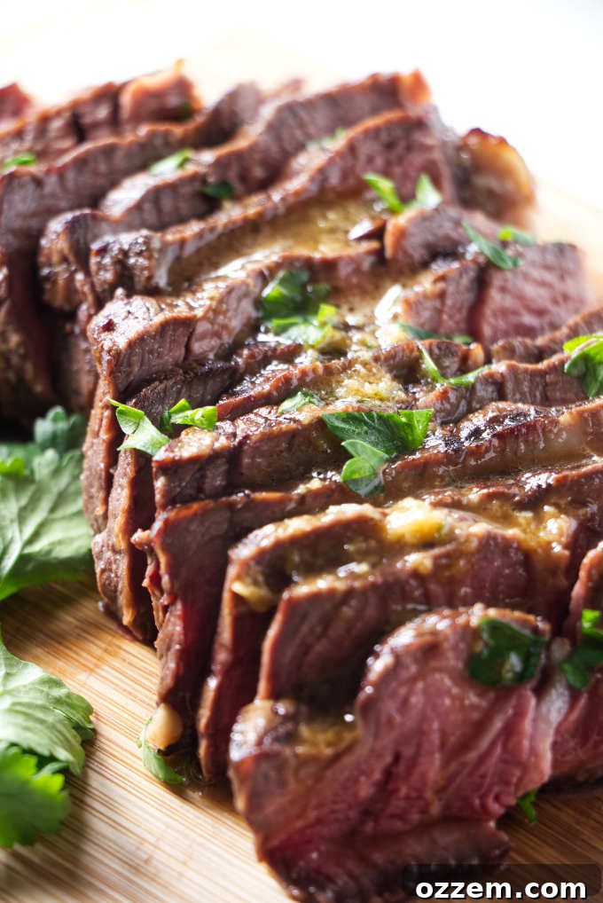 Sunburst Chili Steak Marinade 2 Slices of perfectly marinated and cooked steak, ready to be served, showcasing the rich color and tender texture achieved with the orange chili marinade.