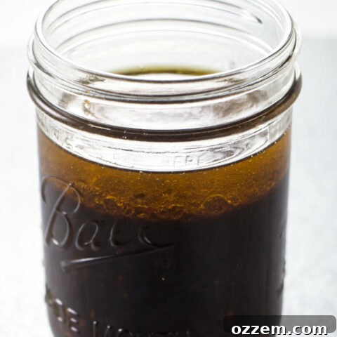 A jar filled with orange chili steak marinade, ready to infuse flavor into any meat.