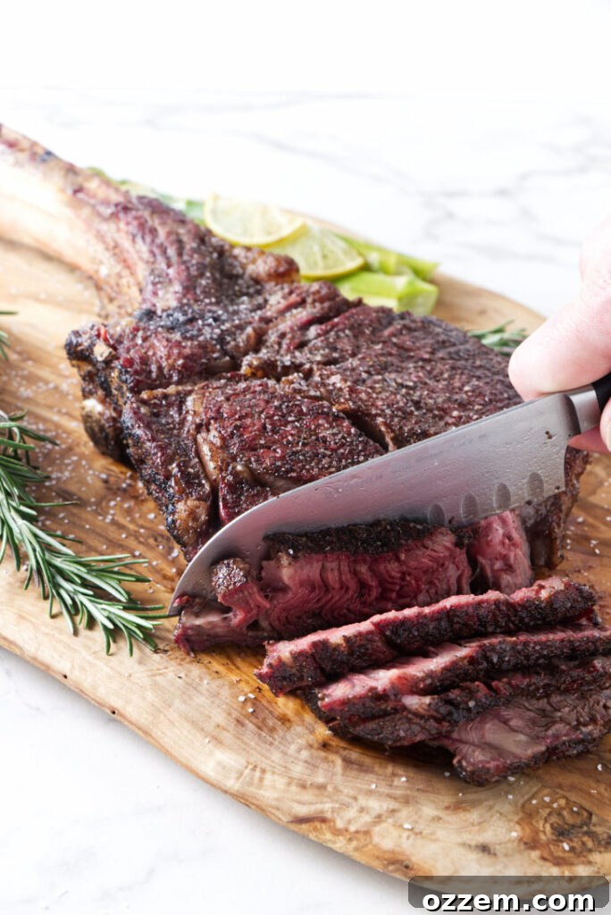 Close-up of a perfectly reverse seared tomahawk steak with a beautiful golden-brown crust.