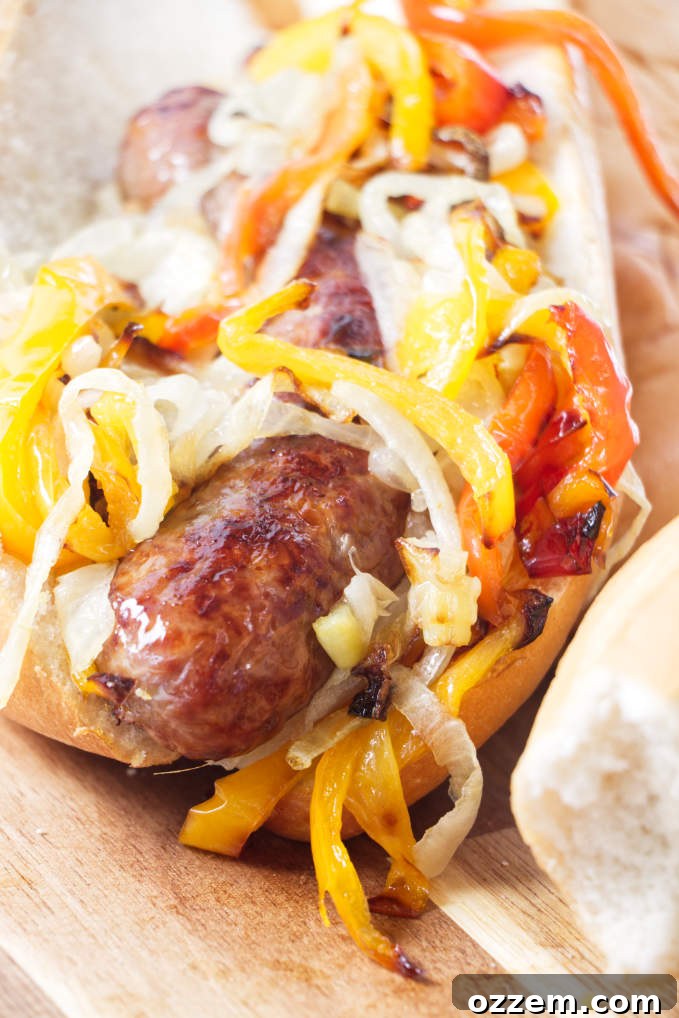 Perfect Air Fryer Brat Sandwiches 7 A bratwurst sandwich with onions, peppers, and cheese.