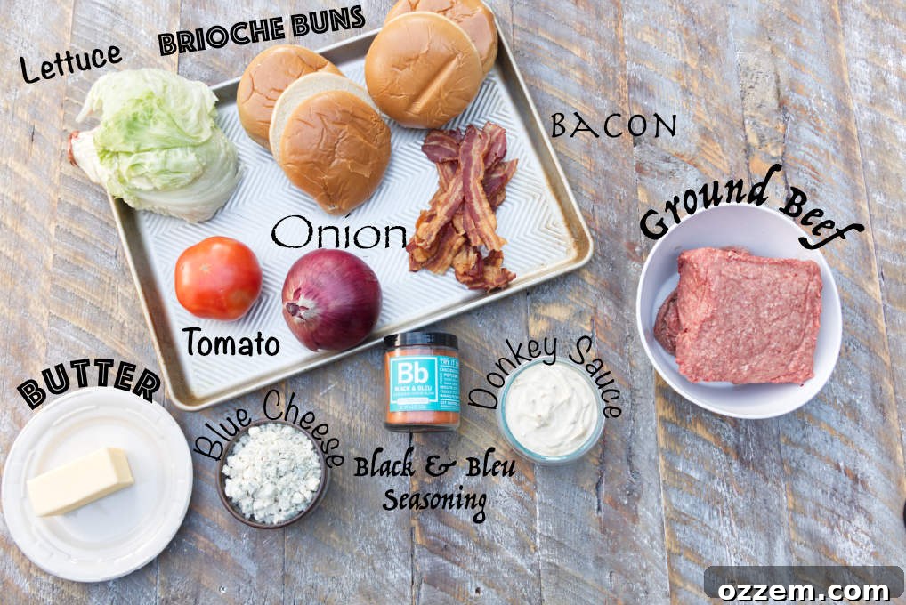 ingredients for blackstone blackened blue cheese stuffed burgers: brioche buns, lettuce, butter, tomato, onion, bacon, black & bleu seasoning, donkey sauce, ground beef