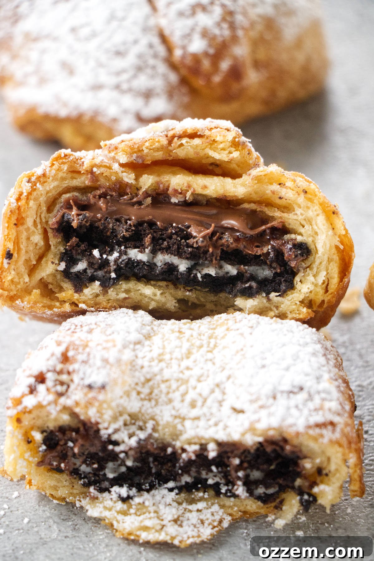 Warm & Gooey Air Fryer Nutella Oreos 7 Two air fried oreos that have been bitten into with chocolate nutella dripping out.