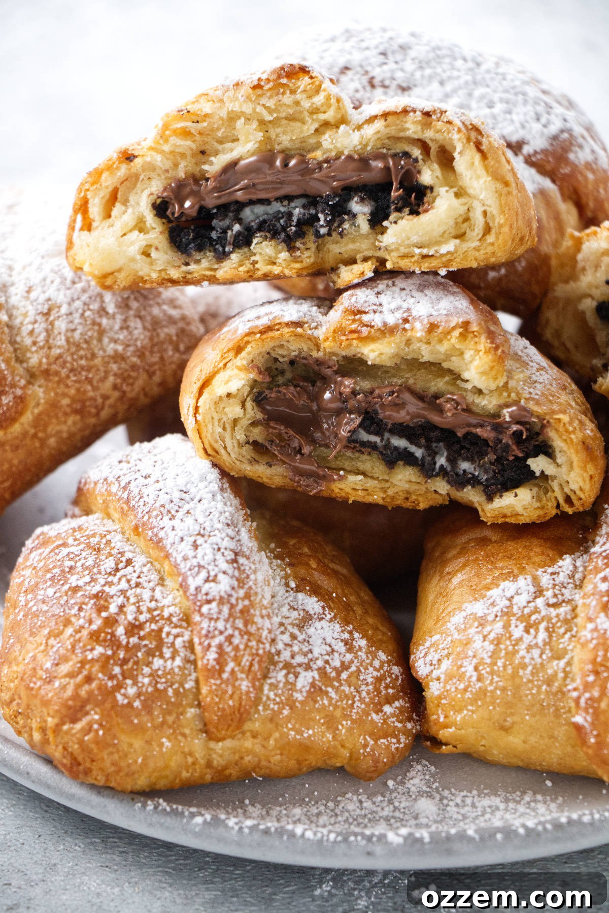 Warm & Gooey Air Fryer Nutella Oreos 8 air fried oreos stacked in a pile and dusted with powdered sugar.