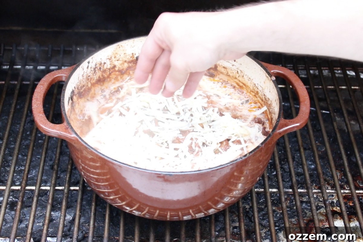 adding parmesan cheese to ragu in dutch oven