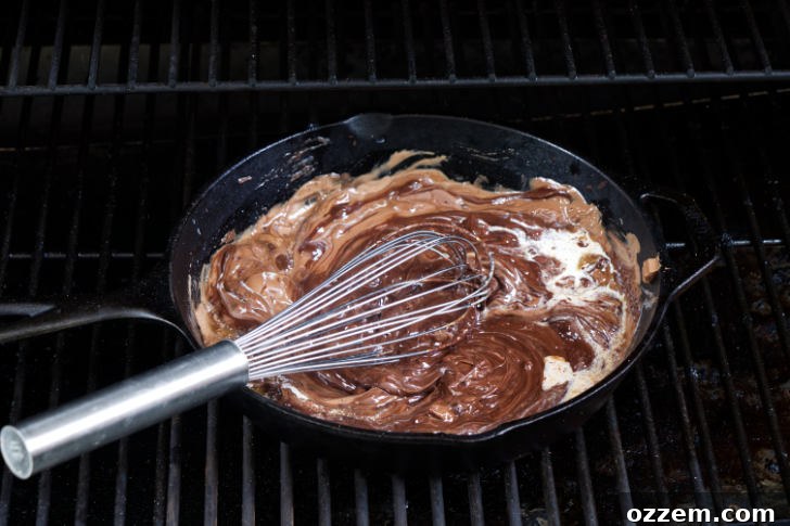 Stirring cream into melted chocolate.