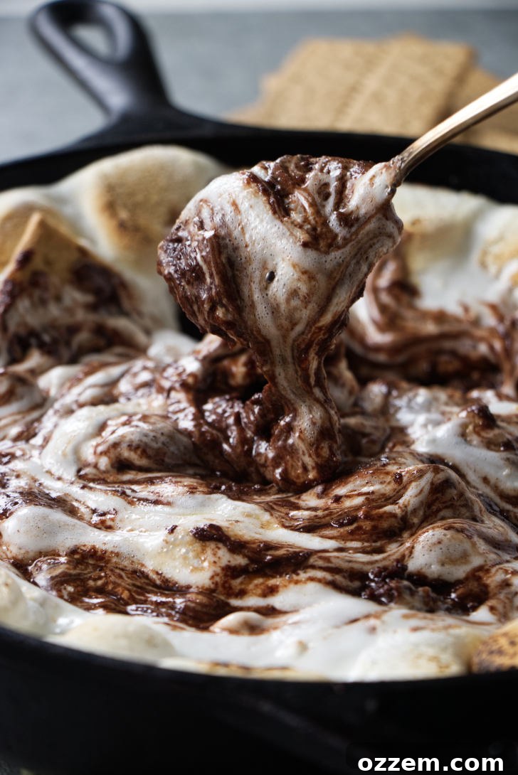 Stirring chocolate and marshmallows together.