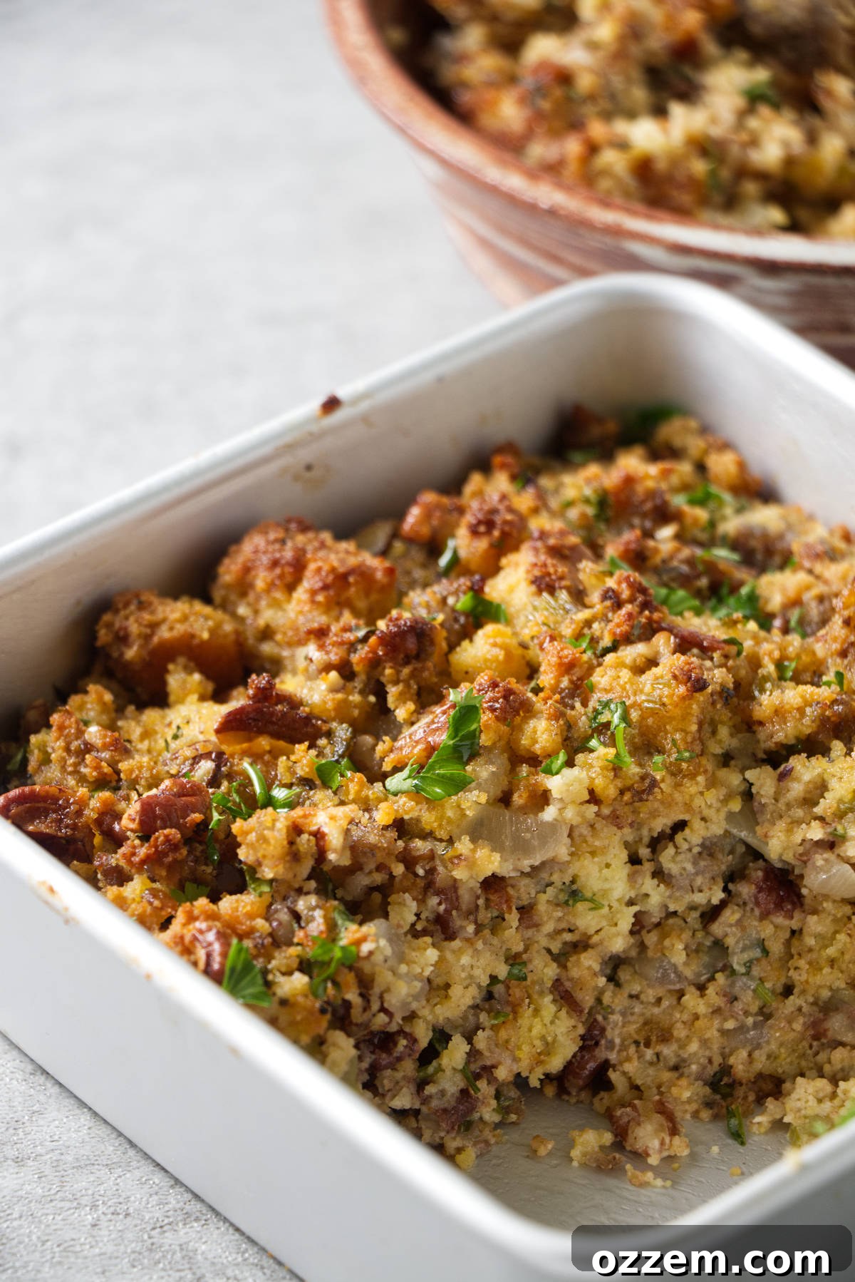 A close-up of golden-brown air fryer stuffing, perfectly cooked in a pan, showcasing its crispy top, ready to be served and enjoyed.