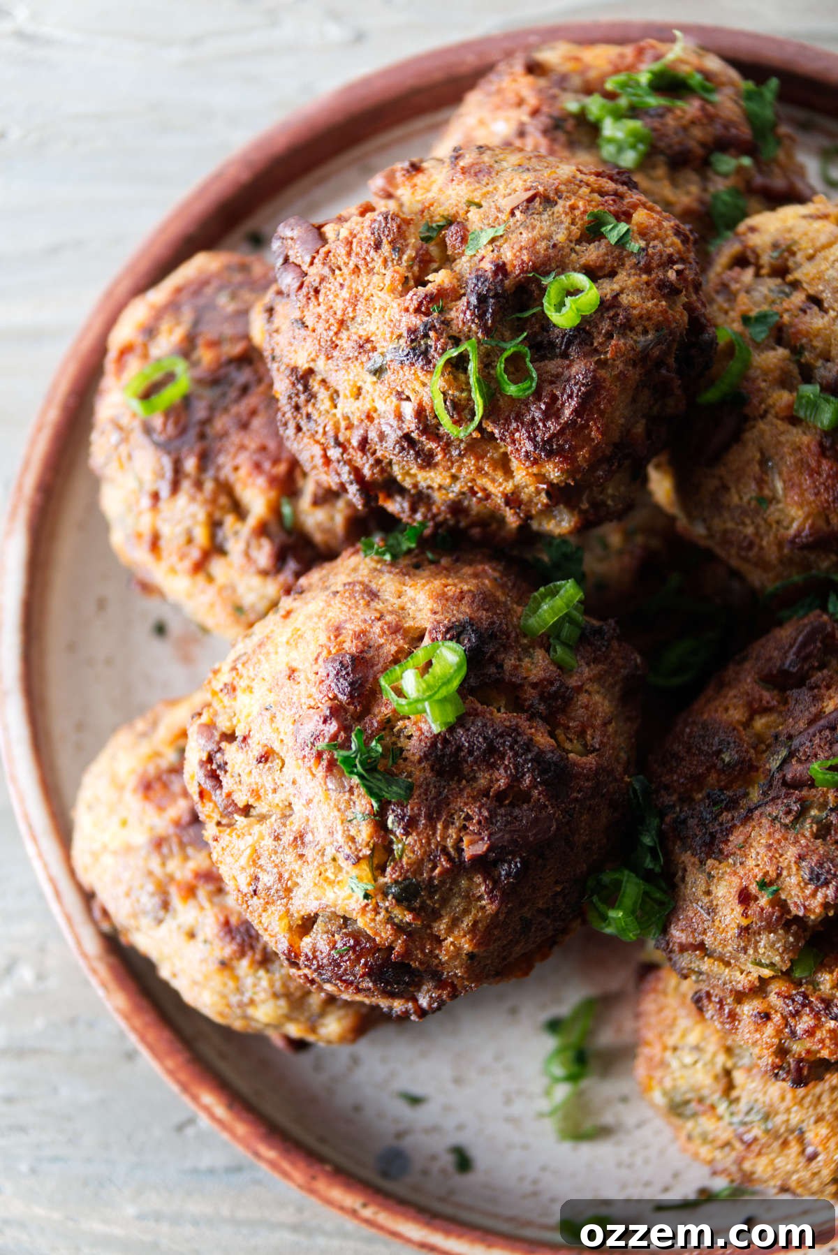 air fryer stuffing balls plated in a stack, golden brown and perfectly round