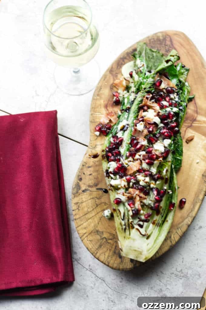 Flame-Kissed Romaine 3 Grilled romaine salad served with a generous amount of blue cheese and bacon, drizzled with a creamy dressing.
