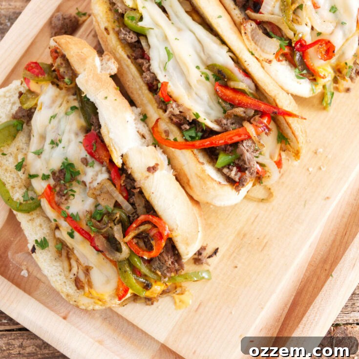 Blackstone Philly Cheesesteak on a cutting board, garnished with fresh herbs.