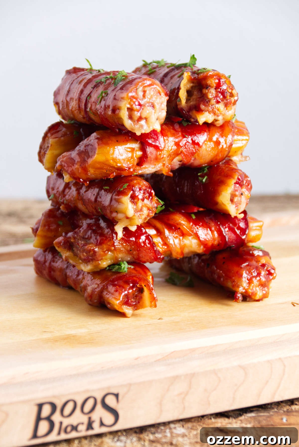stacked sausage stuffed manicotti shells wrapped in bacon and BBQ sauce