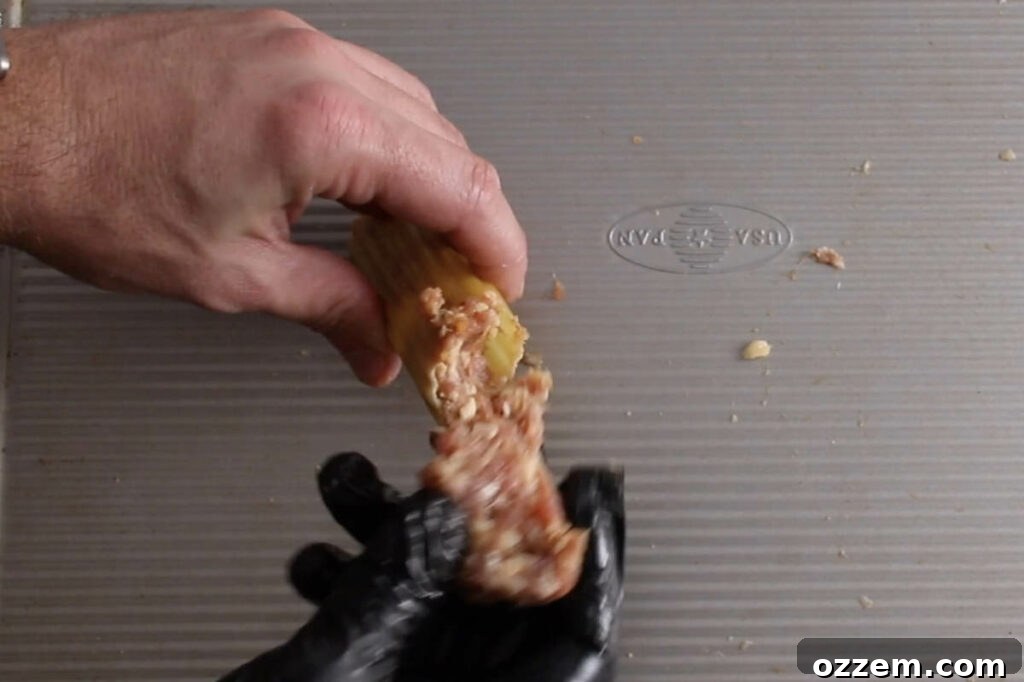 stuffing sausage into manicotti shells
