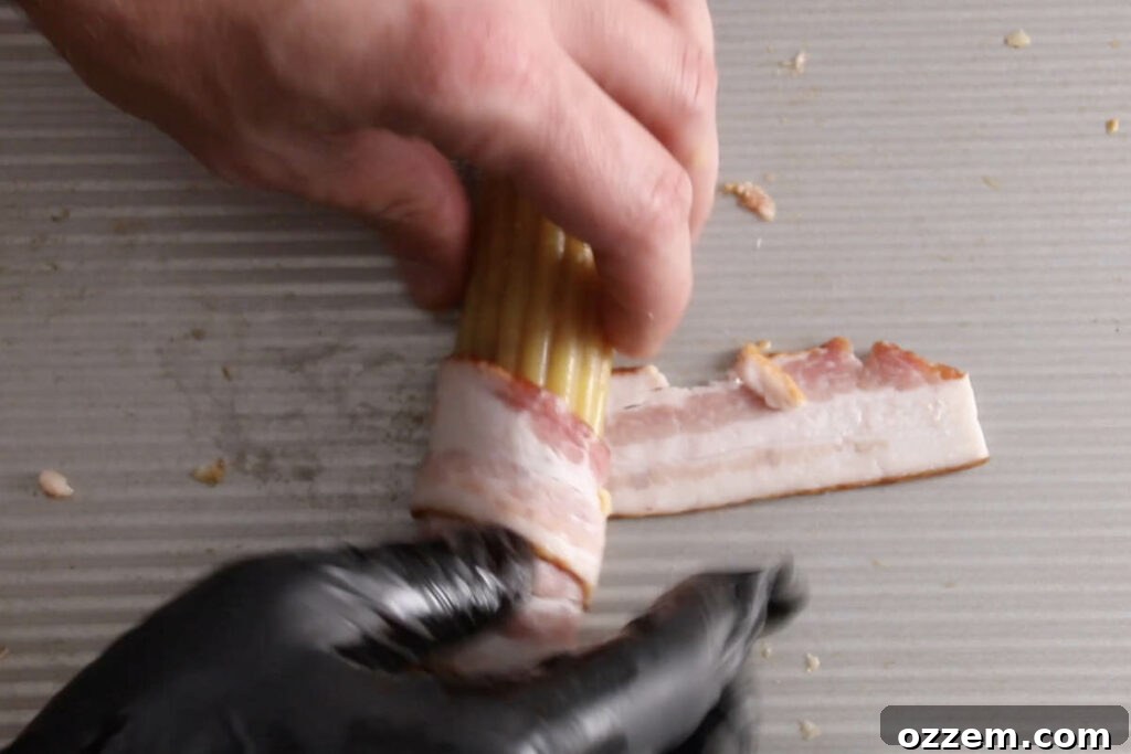 rolling manicotti shell to wrap in bacon