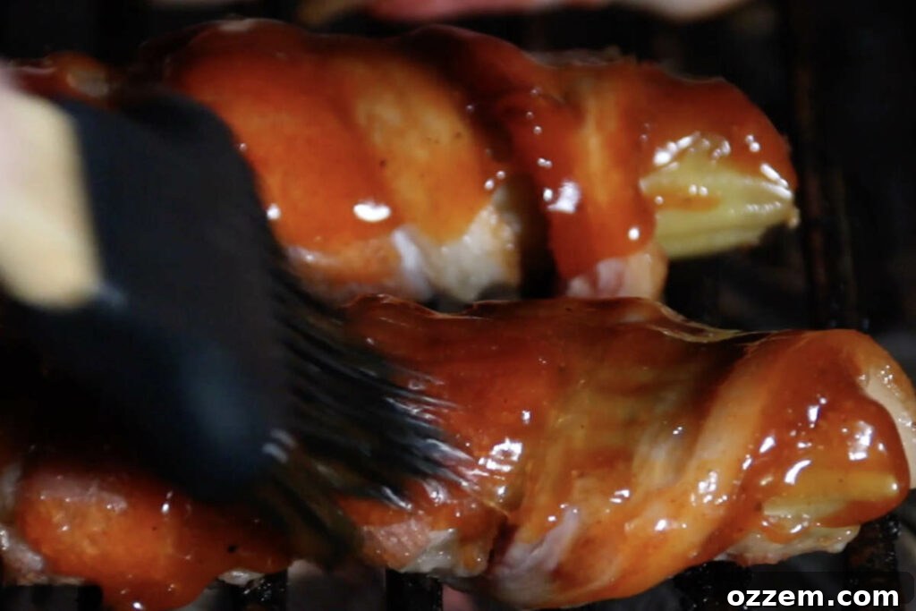 brushing bbq sauce on smoked shotgun shells