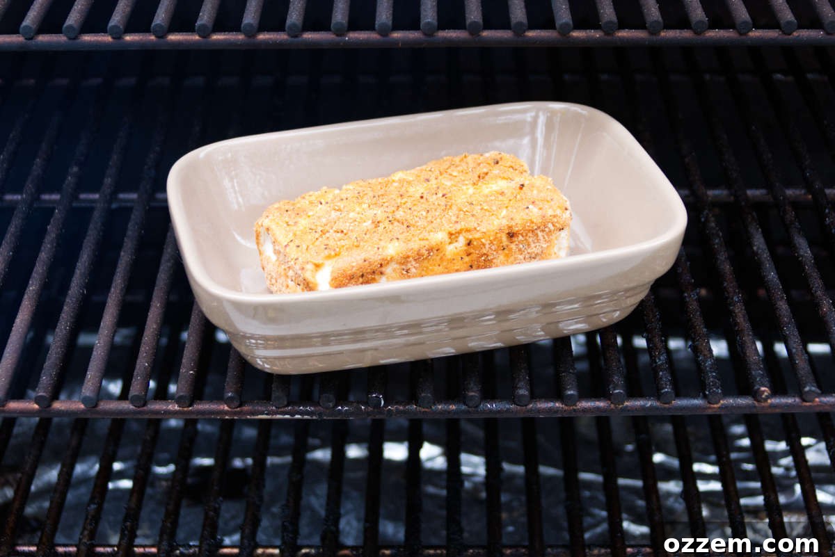 Decadent Smoked Cream Cheese 5 block of cream cheese in baking dish sitting on Traeger grates