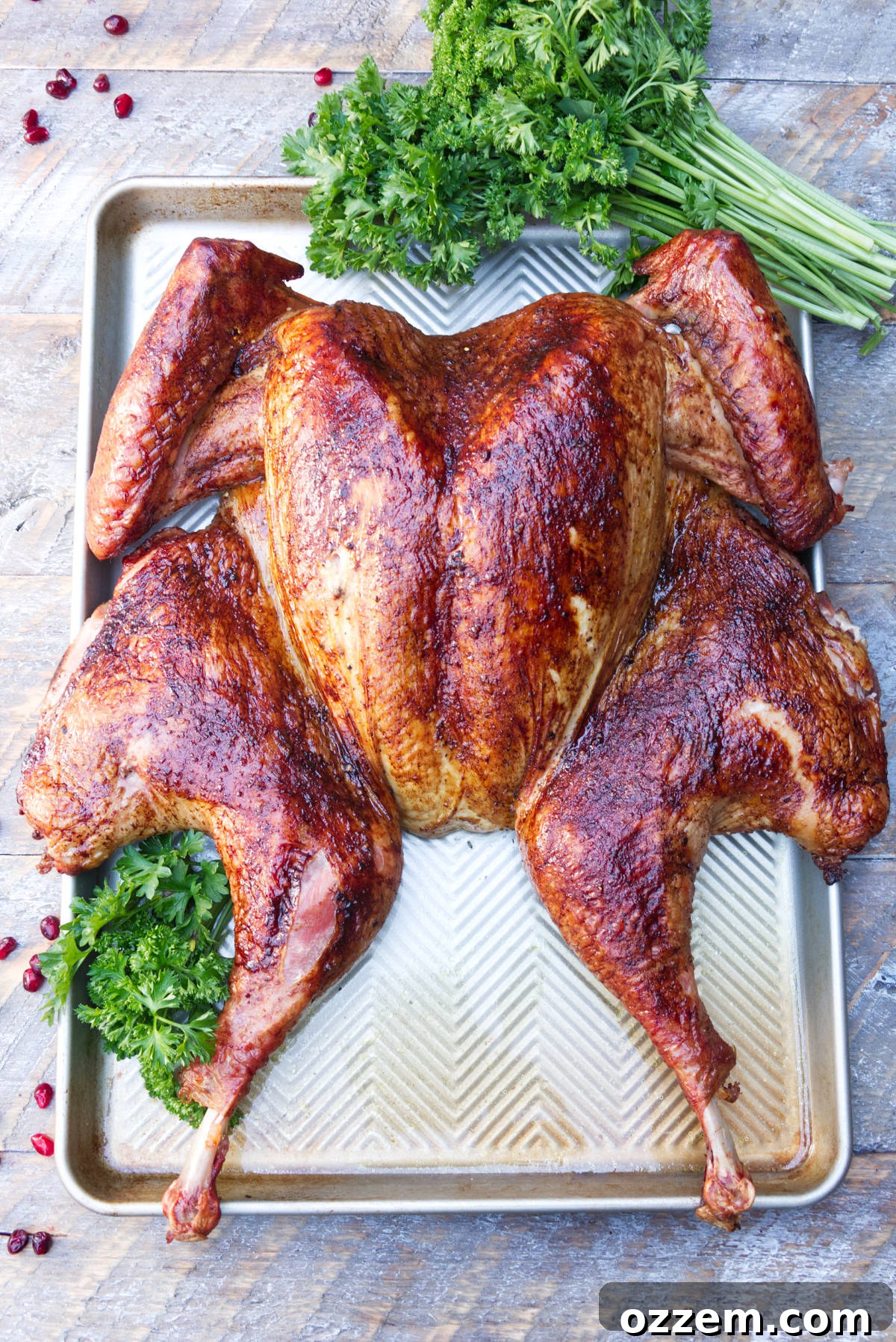 Smoked spatchcock turkey on baking sheet ready to be carved