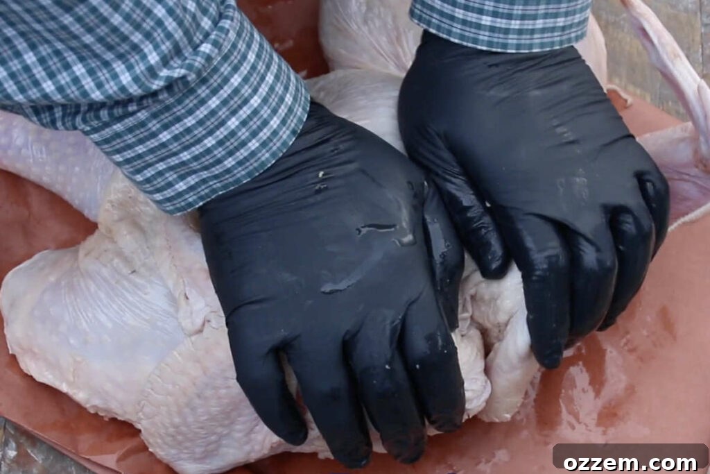 pressing down on breast of turkey