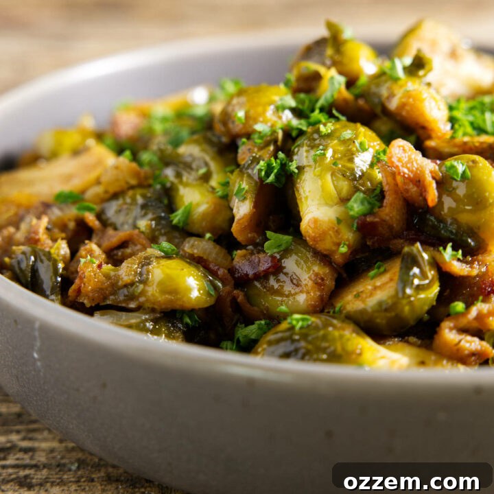 Smoked Brussels sprouts served in a bowl with a drizzle of hot honey on top
