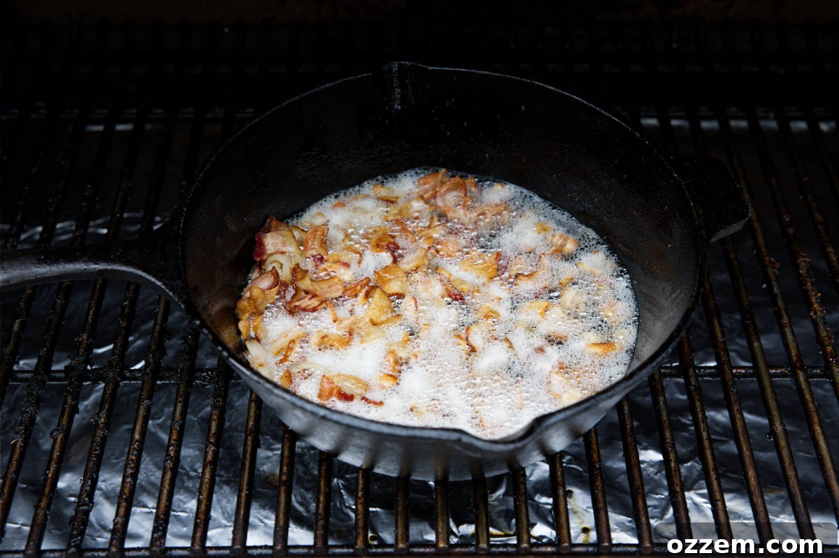 Close-up of bacon cooking in a cast iron skillet on a smoker
