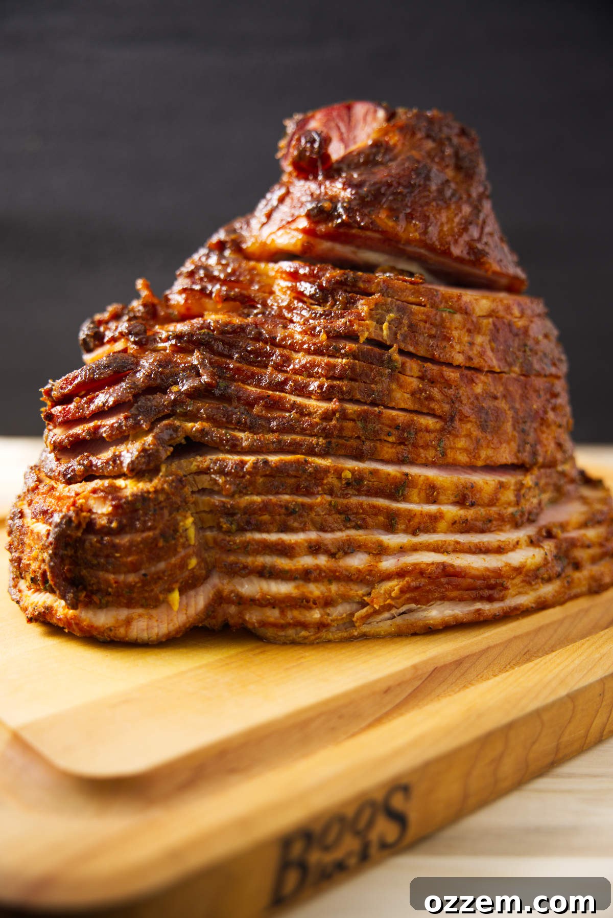 A close-up view of beautifully spiral-sliced, juicy double smoked ham, showcasing its perfect texture and rich, glossy glaze.