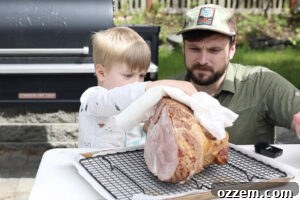 Patting dry the spiral cut ham.