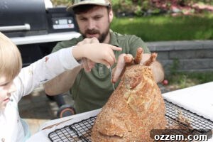 Placing thermometer in spiral cut ham.
