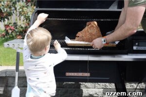 Placing spiral cut ham on the smoker.