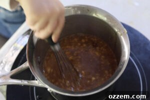 Simmering the glaze in a medium saucepan.