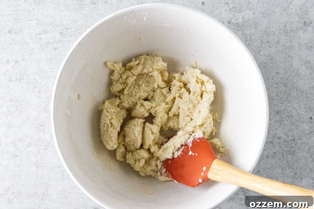 mixing dry ingredients of biscuit topping of cobbler